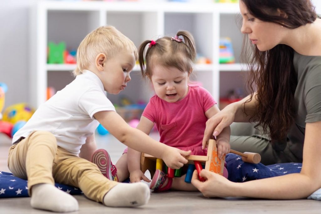 Children playing with a daycare worker