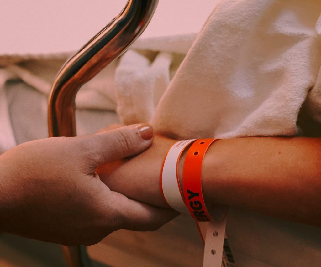 Person holding a patient's hand